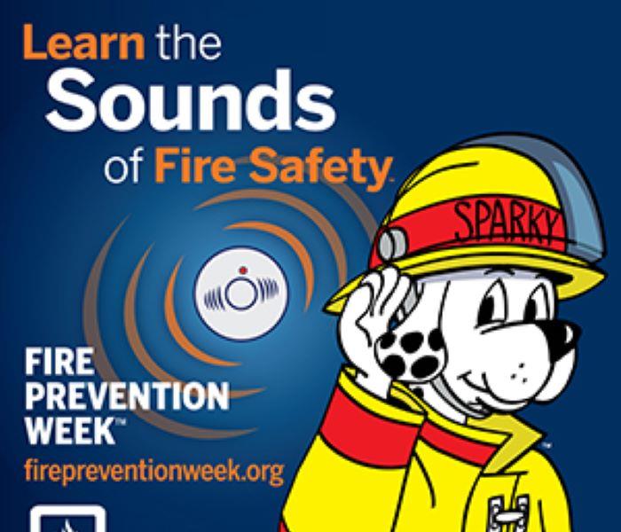National Fire Prevention week text with picture of Sparky the fire dog in fireman's outfit