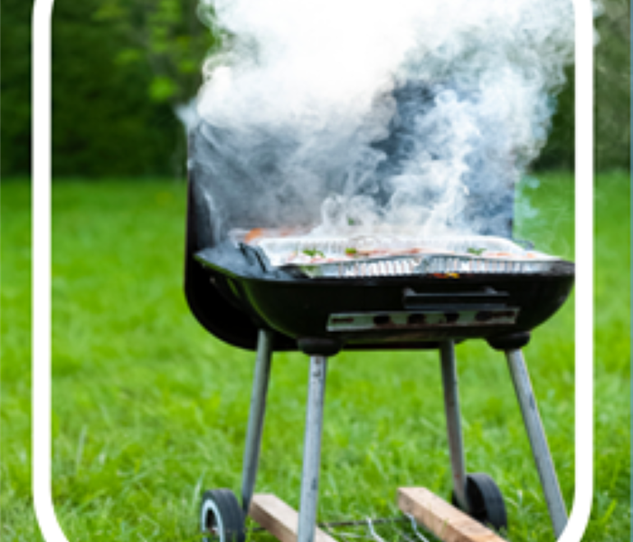 Picture of a grill with smoke pouring out the top