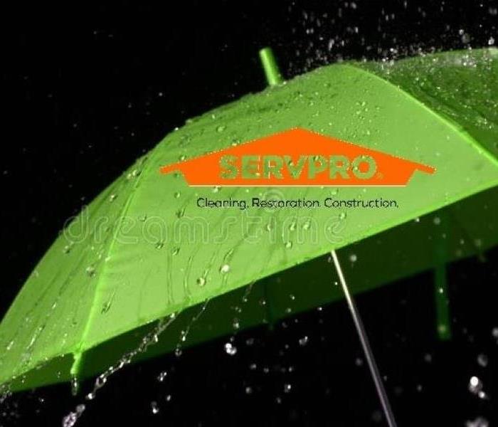 SERVPRO orange logo on a green umbrella with rain drops